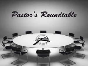 A round table with chairs around it