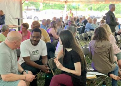 A group of people sitting around in chairs.