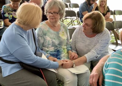 A group of people sitting around each other.