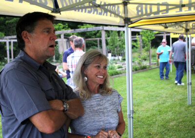 A man and woman standing under an umbrella.