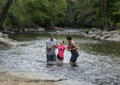 A group of people standing in the water.