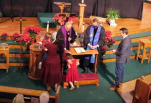 A group of people standing around a church.