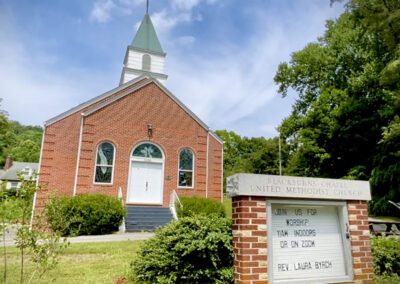 Red brick United Methodist chapel with sign