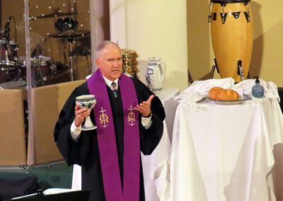 A man in robes and holding a cup