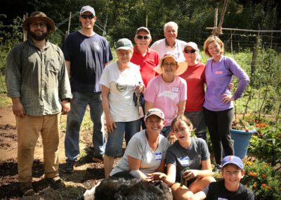 Community volunteers smiling in a vegetable garden