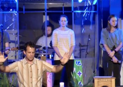 Worship leaders praying with raised hands