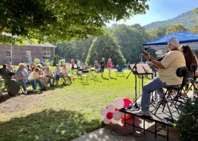 Musicians on stage at outdoor community concert
