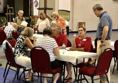 Seniors conversing at community event table