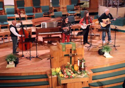 A group of people in a church with instruments.