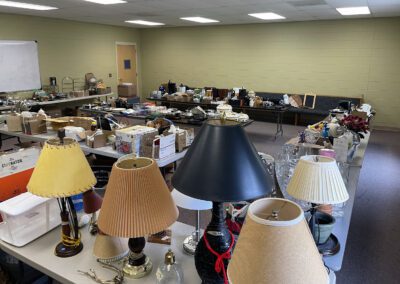 Room of tables filled with lamps and items