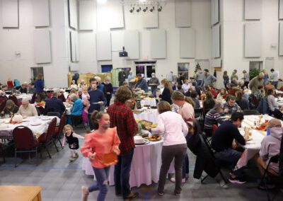 A large group of people gathered at tables.
