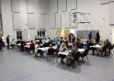 Community dinner in gymnasium with tables