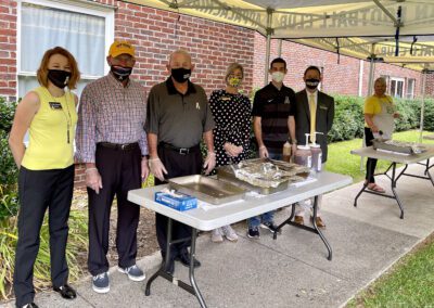 Masked volunteers serving food