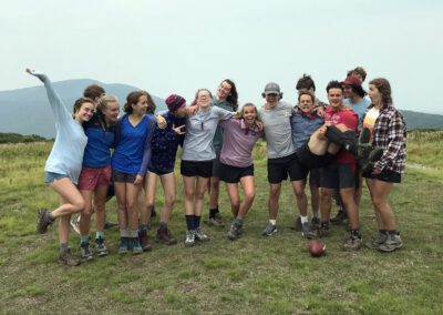 A group of people standing on top of a grass covered field.